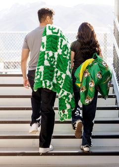 University of Oregon Ducks Blanket wrapped around friends walking up steps, showcasing vibrant green and team spirit.