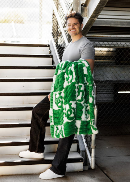 University of Oregon Ducks Blanket held by a smiling man on stairs, showcasing team spirit and comfort.