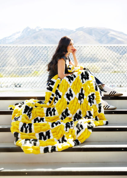 University of Missouri Tigers Blanket draped over a young woman sitting on stadium bleachers.