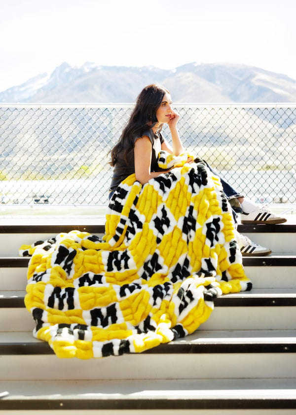 University of Missouri Tigers Blanket draped over a young woman sitting on stadium bleachers.