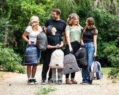 A family enjoying outdoor time with the Black Geo Everywhere Blanket, demonstrating its portability and style in nature.