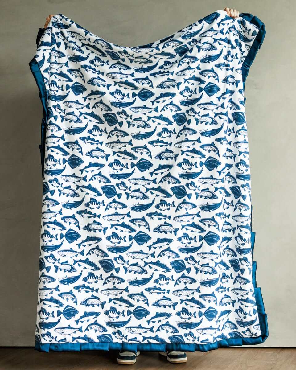 Minky Couture Fisher Blanket featuring playful blue fish designs on a white background.