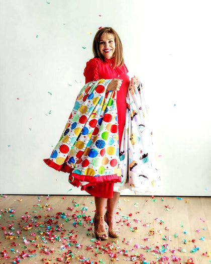 Minky Couture Happy Birthday Blanket displayed by a smiling woman, surrounded by colorful confetti.