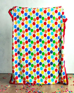 Happy Birthday Blanket showcasing a vibrant print of colorful balloons, perfect for celebrating any occasion.