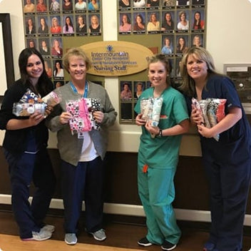 Nursing staff at Intermountain holding gift bags, showcasing teamwork and community support.