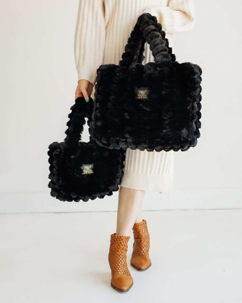 Model showcasing Ripple Black Annie Bag in two sizes, highlighting its luxurious texture and stylish design.