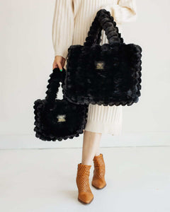 Model showcasing Ripple Black Annie Bag in two sizes, highlighting its luxurious texture and stylish design.