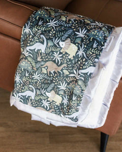 Little Dino Gray Blanket featuring a whimsical dinosaur design with silver satin ruffle, perfect for a child's room.