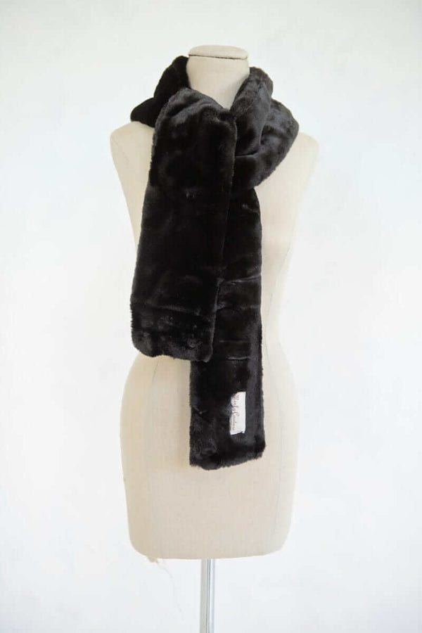 Lush Scarf displayed on a mannequin, showcasing its soft, plush texture in classic black for cozy winter style.