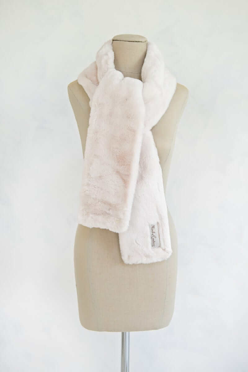 Lush Scarf in macadamia nut color displayed on a mannequin, showcasing its soft, plush design perfect for winter wear.