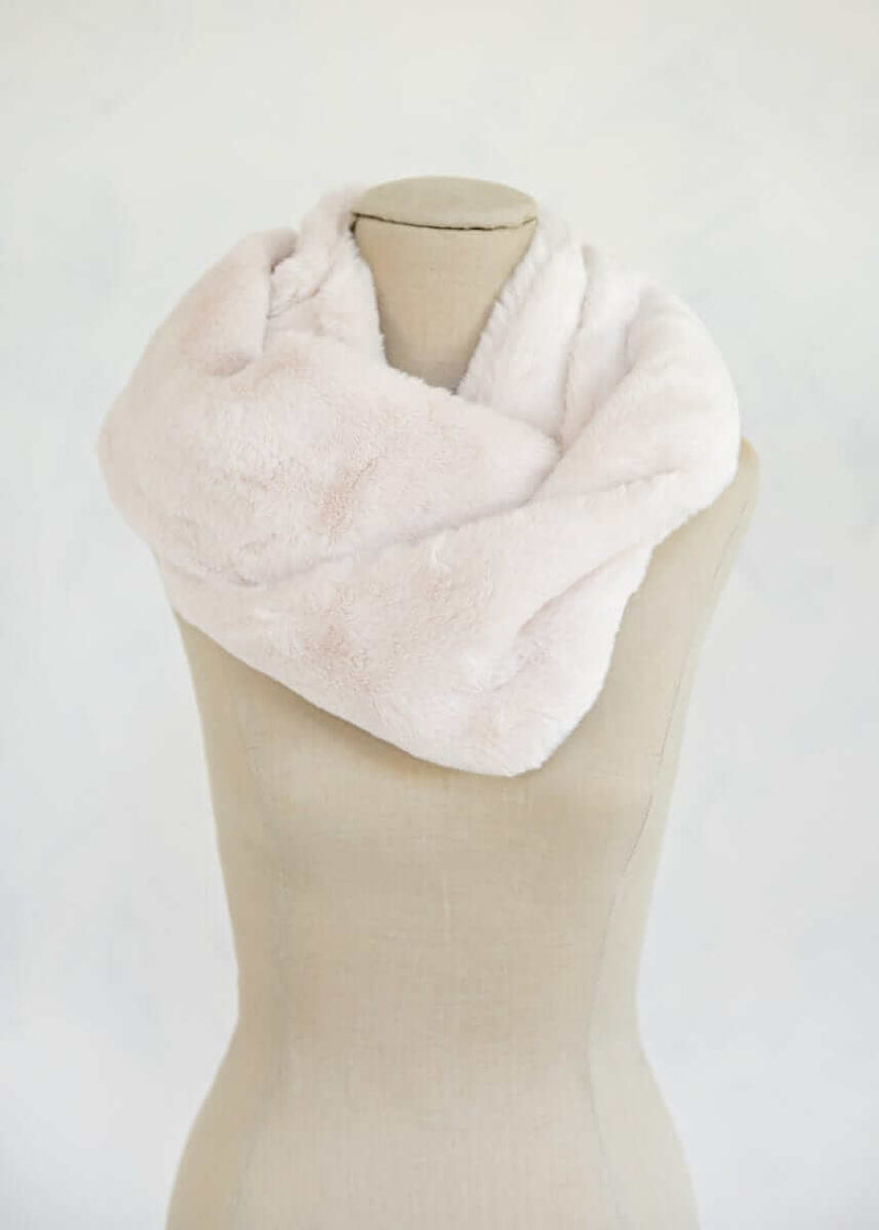 Lush Scarf in macadamia nut color displayed on a mannequin, showcasing its soft and cozy plush texture, ideal for winter wear.