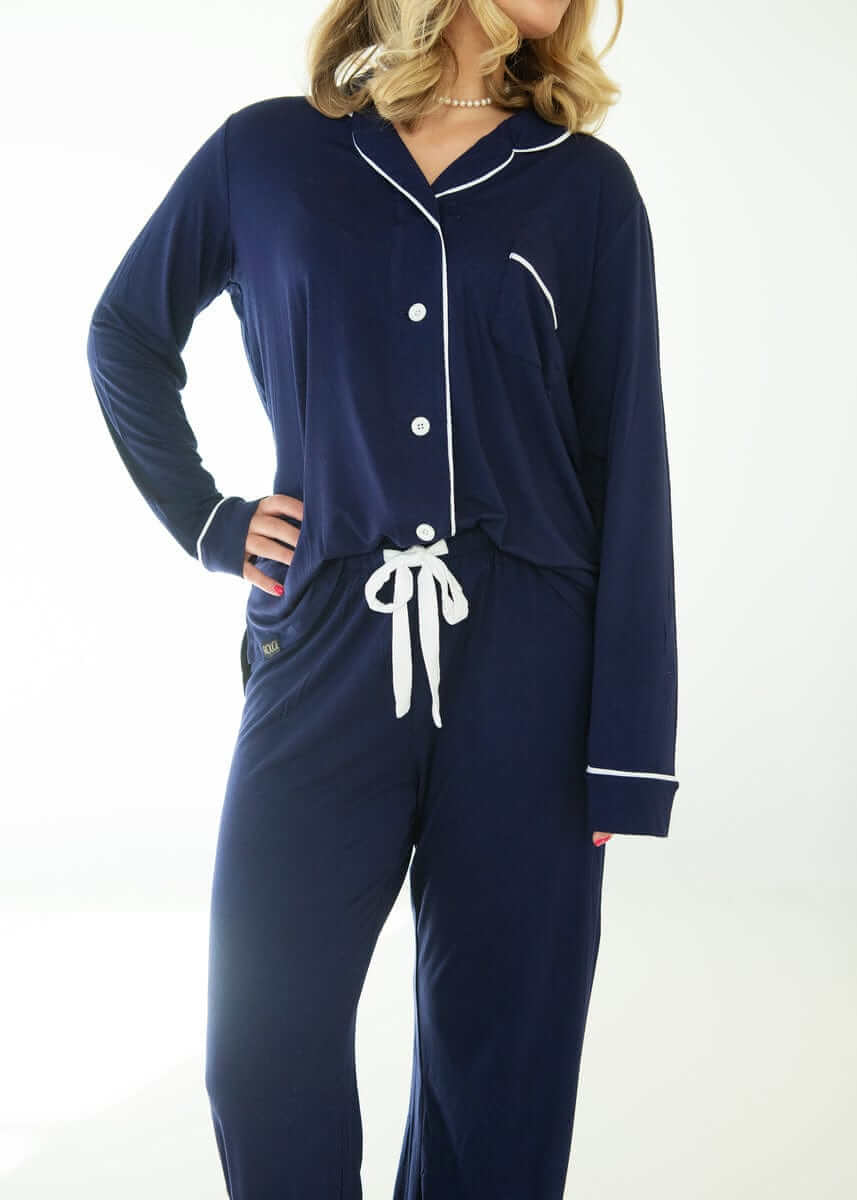 Model wearing Middle of the Night Pajamas in Navy Evening Blue, featuring a button-up top and straight-leg pants.