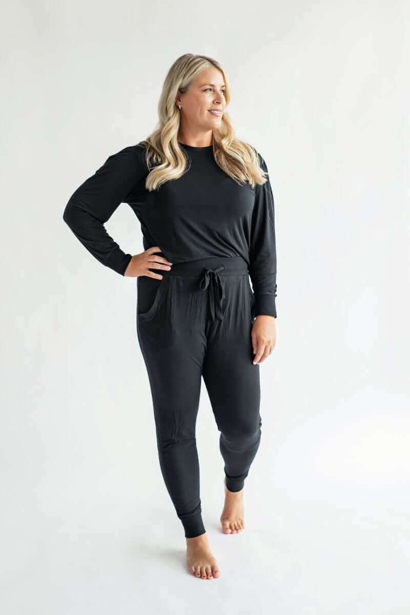 Model wearing cozy two-piece set in black from the Must be Bamboo Pajamas.