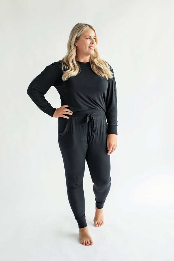 Model wearing cozy two-piece set in black from the Must be Bamboo Pajamas.