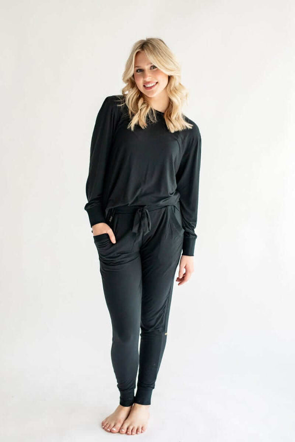 Model wearing Must be Bamboo Pajamas in Black, a cozy and stylish two-piece bamboo sleep set.