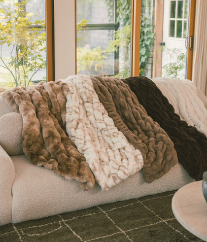 Couch with 4 neutral brown minky blankets