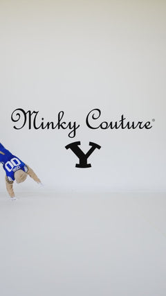 BYU Cougars mascot holding a blue and white Minky Couture collegiate blanket in a studio setting.