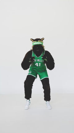 Utah Valley Wolverines mascot holding a green Minky Couture collegiate blanket in a studio setting.