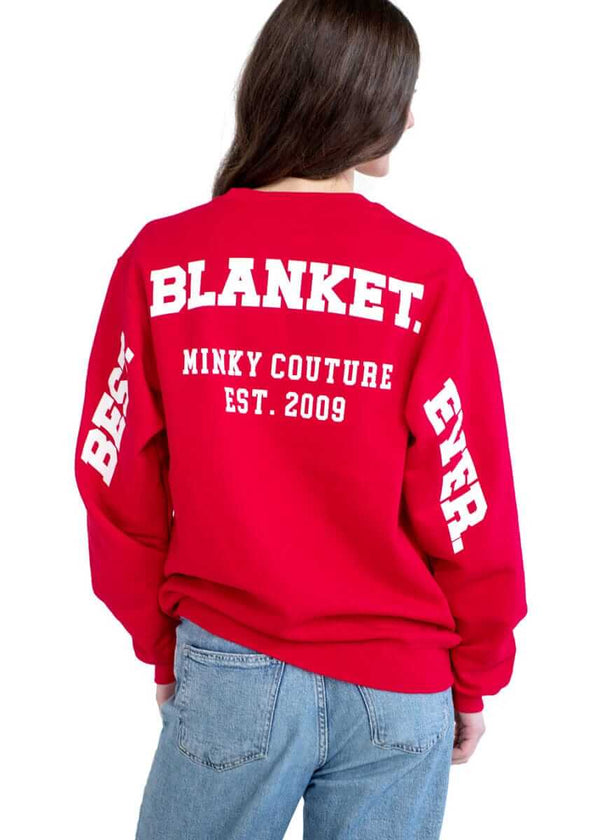 Person wearing a red Minky Couture sweatshirt with “Best Blanket Ever” text on the back.