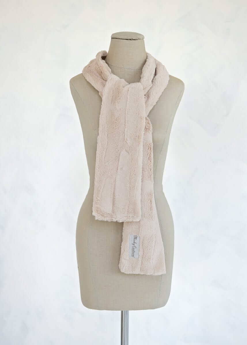 Sorbet Scarf displayed on a mannequin, showcasing its smooth texture and light warmth in Almond Croissant color.