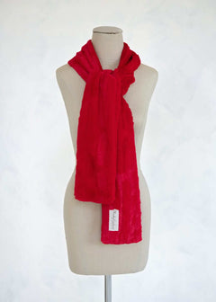 Sorbet Scarf in vibrant red displayed on a mannequin, showcasing its smooth texture and versatile style.