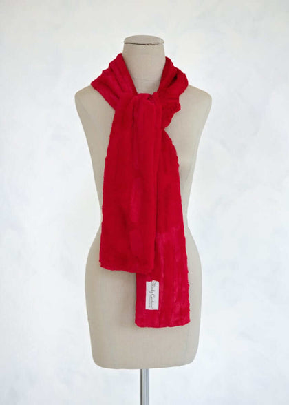 Sorbet Scarf in vibrant red displayed on a mannequin, showcasing its smooth texture and versatile style.