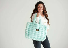 Woman holding the Annie Bag Ripple Tiffany in mint green, showcasing its luxurious texture and stylish design.