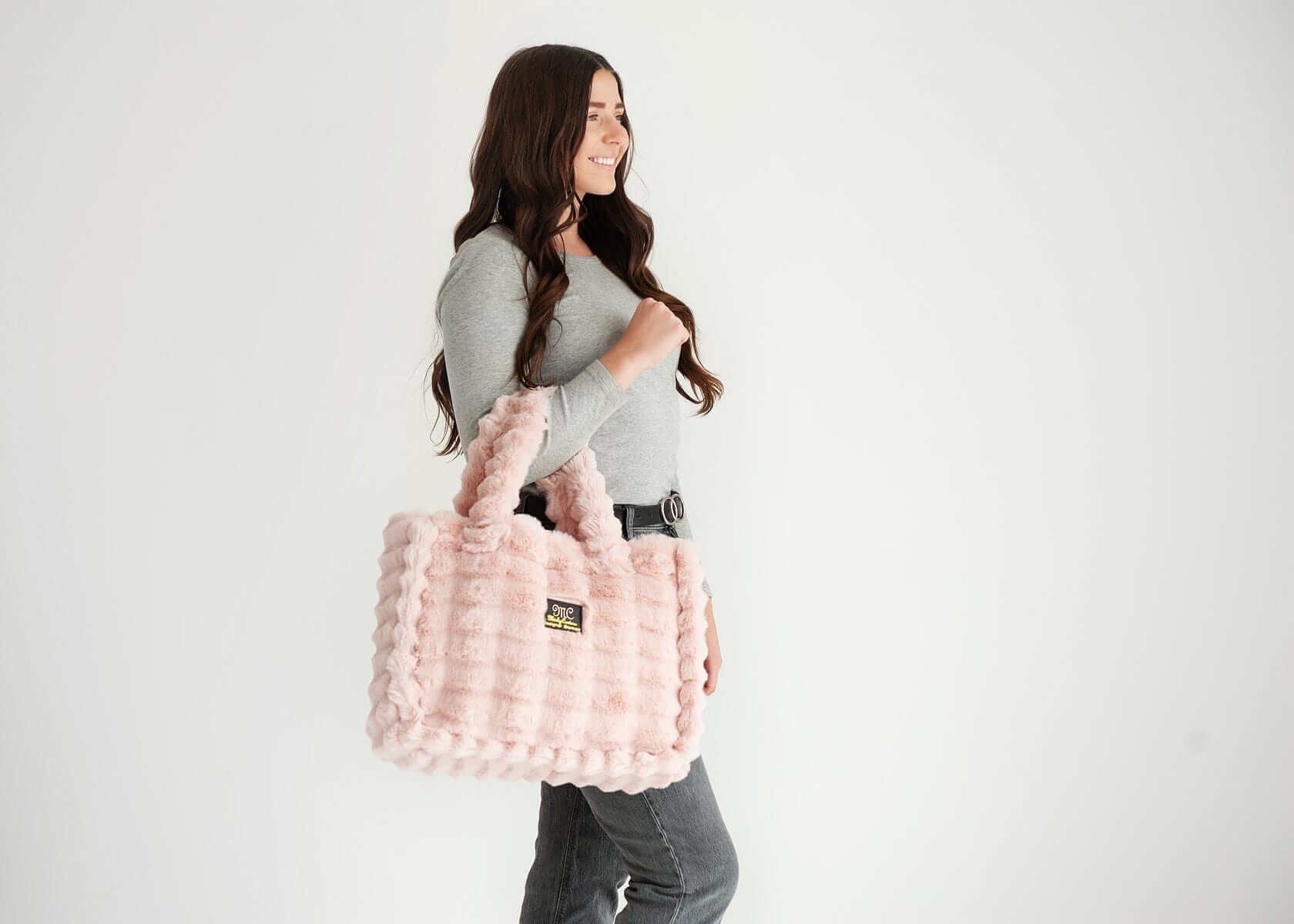 Model showcasing the Annie Bag Ripple Blush, a stylish and versatile accessory in luxurious texture.