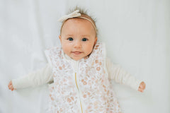Dainty Floral Wearable Minky Blanket on a baby girl, featuring soft floral patterns and a gold zipper.