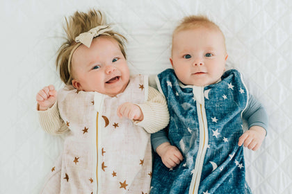 Navy Stars and Moons Wearable Minky Blanket on two infants, one wearing navy blue with stars and moons.