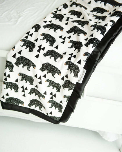 Black and cream My Bear patterned blanket with triangle accents. 