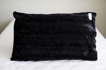Black | Black plush pillowcase by Minky Couture sitting on a bed. 