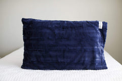 Navy | Navy blue Minky Couture pillowcase sitting on a bed. 