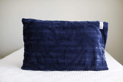 Navy | Navy blue Minky Couture pillowcase sitting on a bed. 