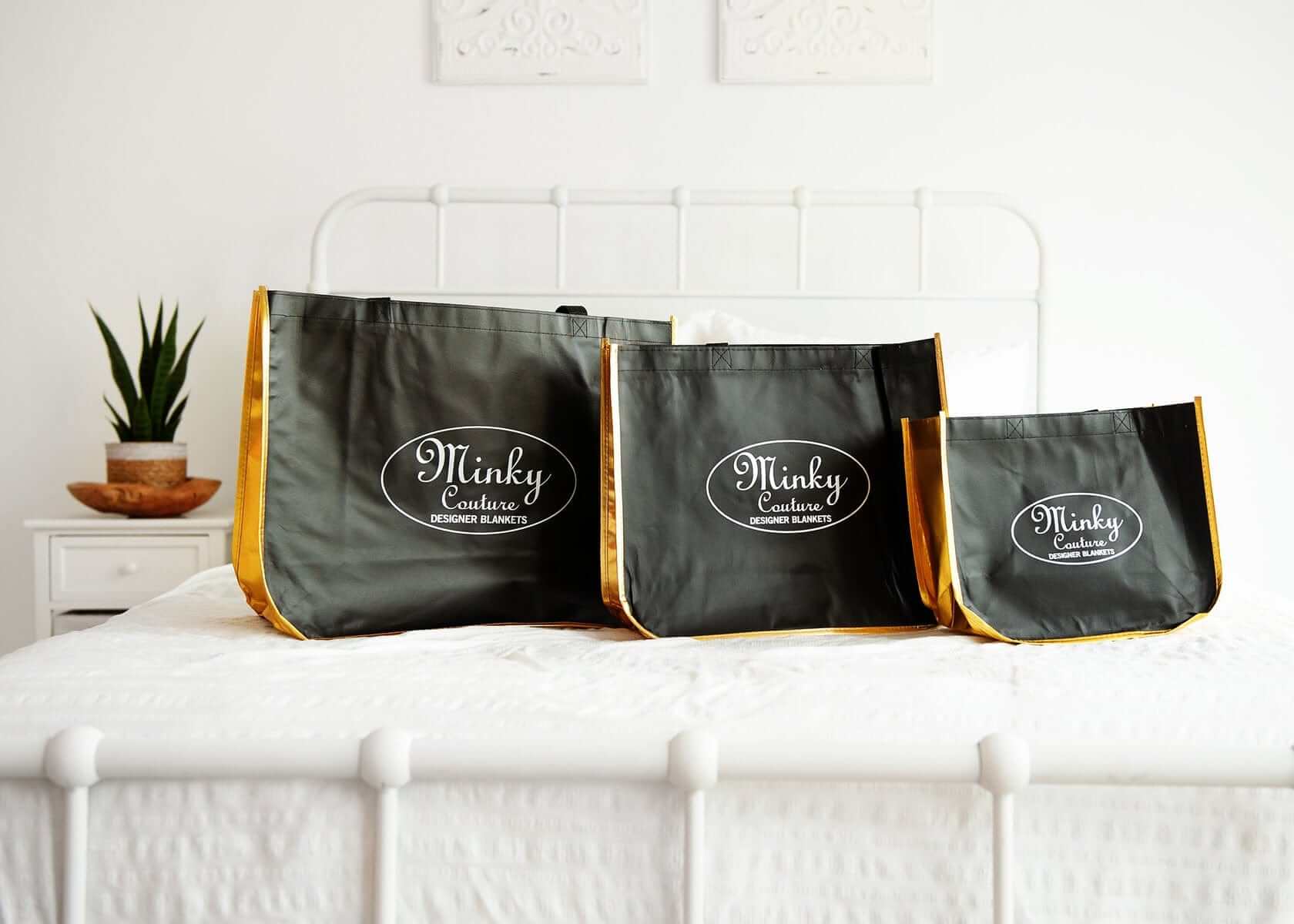Reusable Shopping Bags in three sizes displayed on a bed, ideal for groceries and gifts.