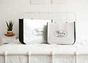 Two Minky Couture reusable Shopping Bags displayed on a bed, showcasing their design and versatility for various uses.