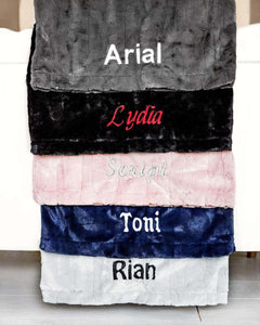 Five pillows of various colors embroidered with five different fonts to show options available to personalize a pillow. 