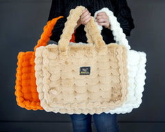 Annie Bags displayed in three colors: orange, beige, and white, showcasing its stylish texture and luxury.