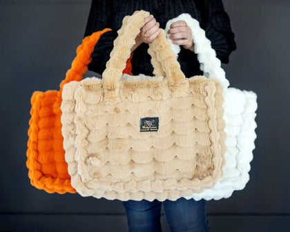 Annie Bags displayed in three colors: orange, beige, and white, showcasing its stylish texture and luxury.