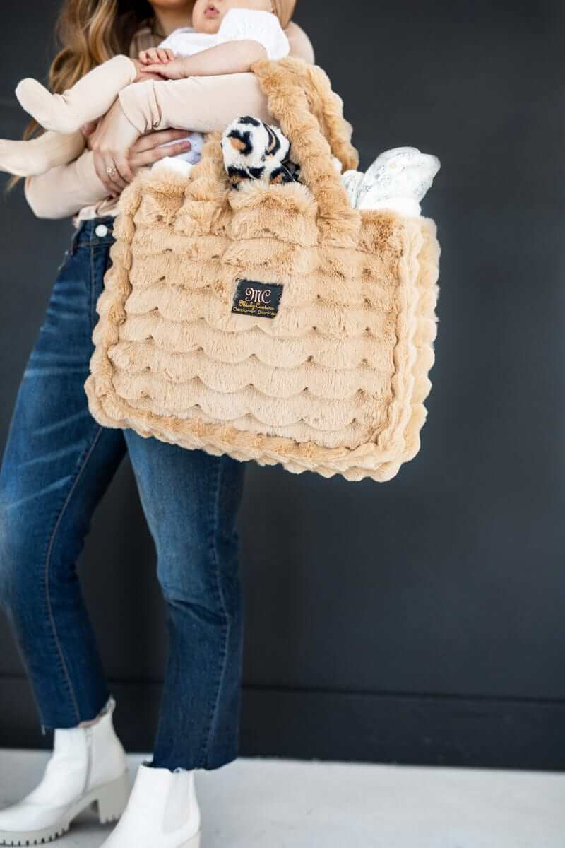 Annie Bag Ripple Ecru being carried, showcasing its luxurious style and texture with a plush design.