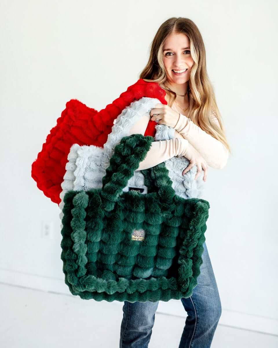 Annie Bags showcased in colorful plush textures held by a smiling model, highlighting luxurious style.